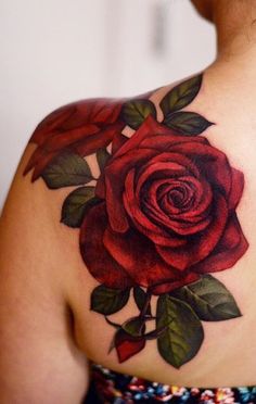 a woman with a rose tattoo on her shoulder