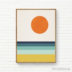 an orange sun on a white brick wall in front of a wooden frame hanging on the wall