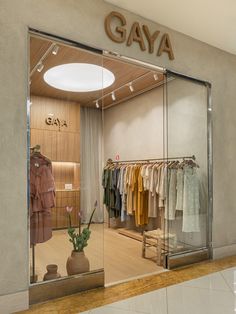 a clothing store with glass doors and clothes on display