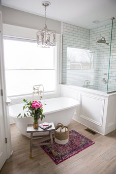 a white bath tub sitting next to a window