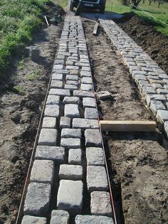 a truck is parked on the side of a road with bricks laid in front of it