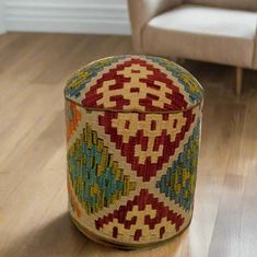 a colorful basket sitting on top of a wooden floor