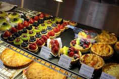 a display case filled with lots of different types of pies