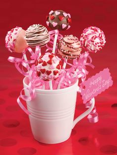 a cup filled with lots of cake pops