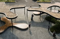 people are walking around an artisticly designed bench