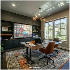 an office with a desk, chair and large window in the center is decorated with colorful rugs