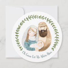 a christmas card with a watercolor painting of a man and woman holding a baby