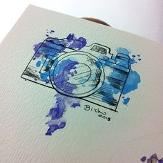 a watercolor drawing of a camera on paper