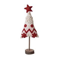 a small white christmas tree with red stars on it's top and a wooden base