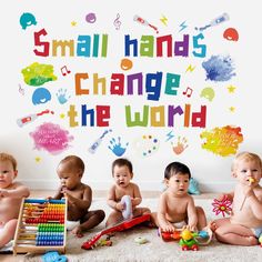 small hands change the world wall decal with babies and toys in front of it