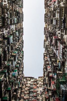 an upward view of many buildings with balconies