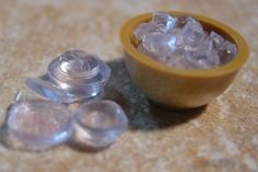 small bowl filled with ice next to two smaller bowls full of ice on the floor