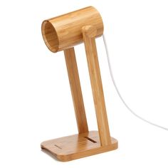 a wooden table lamp with a white cord attached to the base and an electric plugged in