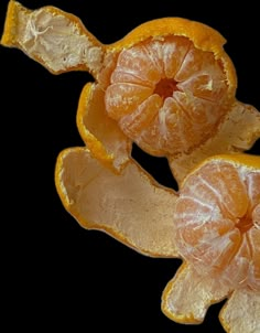 two peeled oranges sitting on top of each other