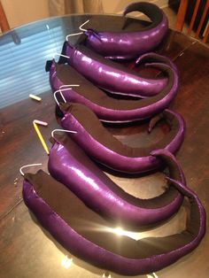 purple shoes are lined up on a table