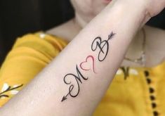 a woman with a tattoo on her arm that says love and an arrow in the middle