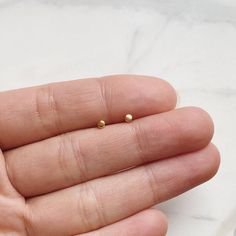 Tiny minimalist circle dot stud earrings — looks great on its own or stacked with our other small studs!•  14k gold plating over sterling silver (hypoallergenic & nickel-free)•  Matching post backing•  Measures about 2mm•  Ships as a pair (2 earrings total)Every order comes nicely packaged, ready for gift-giving! Please note that multiple items in the same order will be combined into one gift box. If the items are meant for separate individuals, please let me know.Also available in sterling silv Minimalist Tarnish-resistant Round Cartilage Earrings, Minimalist Gold Hypoallergenic Cartilage Earrings, Minimalist Round Pierced Cartilage Earrings, Tiny Gold Minimalist Earrings, Tiny Minimalist Gold Earrings, Tiny Minimalist 14k Gold Cartilage Earrings, Tiny Simple Gold Cartilage Earrings, Dainty Tiny Cartilage Earrings, Dainty Tiny Round Cartilage Earrings