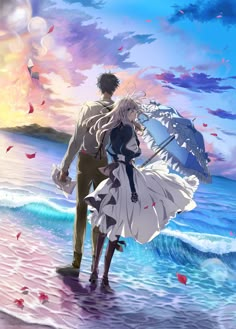 a man and woman standing on the beach with an umbrella in front of their backs