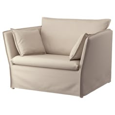 a beige chair with two pillows on the armrests and one pillow in front of it