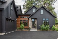 a large house with two garages in the front and one on the other side