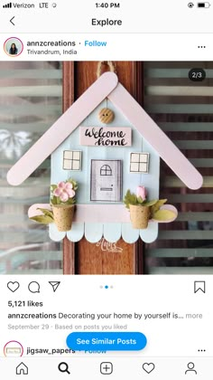 an instagram page with a house made out of paper and some flowers on it