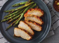 grilled chicken and asparagus on a blue plate