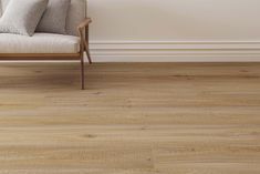 a white couch sitting on top of a wooden floor