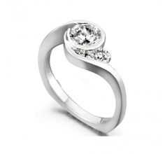 a white gold ring with two diamonds on the top, and one diamond in the middle