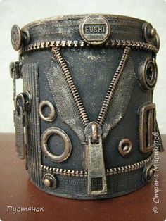 a close up of a leather cuff with zippers and metal rivets on it