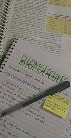 a notepad with the word biomole written on it next to a pen