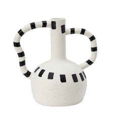 a white vase with black and white stripes on the handle is sitting in front of a white background