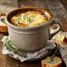 a bowl of soup with bread on the side