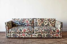 a couch sitting on top of a carpet covered floor