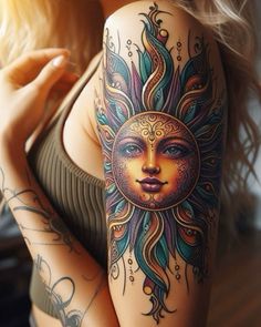 a woman with a sun tattoo on her arm