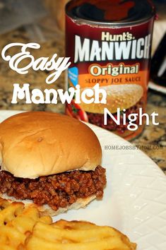 a sloppy joe sandwich and french fries on a plate next to a can of manwich