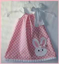 a pink and white polka dot dress with a bunny applique