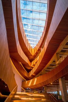 the inside of a building with stairs leading up to it and a skylight above