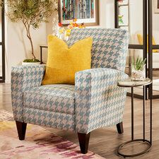 a blue and white chair sitting on top of a wooden floor