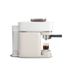 an espresso machine sitting on top of a white counter