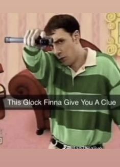 a man in a green and white striped shirt holding a camera to his face with the caption, this clock finna give you a clue