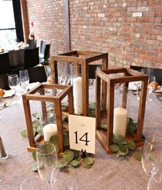 the table is set with candles and place cards