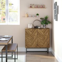 a dining room with a table, chairs and a shelf on the wall above it