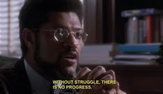 a man in glasses and a tie with a quote on the side that says, without struggle there is no progress