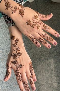 two hands with hendi tattoos on them