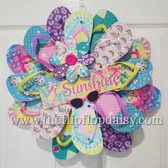 a wreath made out of flip flops with the word sunshine on it's front door