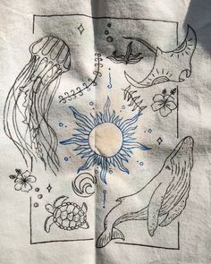 an embroidered piece of cloth with images of animals and sea creatures on it's side