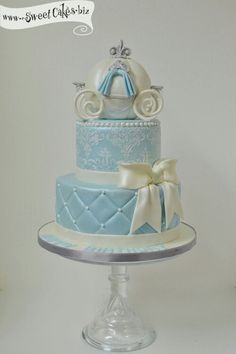 a blue and white cake with a carriage on top