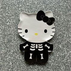 a hello kitty skeleton plate sitting on top of a table