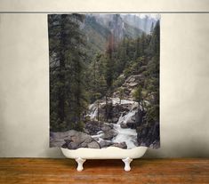 a shower curtain with a waterfall in the woods