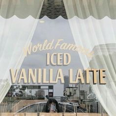 a window with the words world famous iced vanilla latte on it